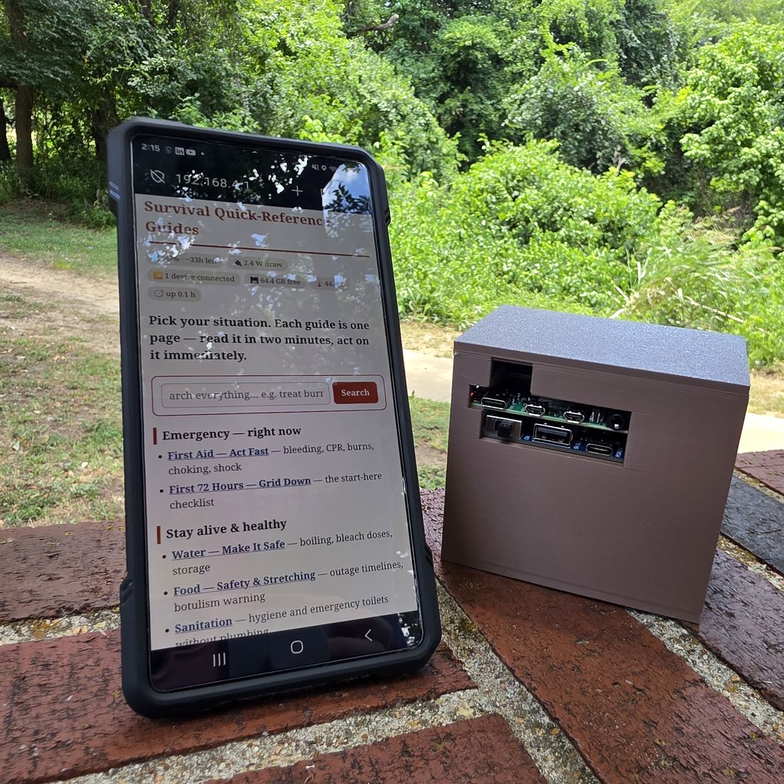 A phone showing the GridFall Library quick-reference guides next to the GridFall box, outdoors with no internet connection